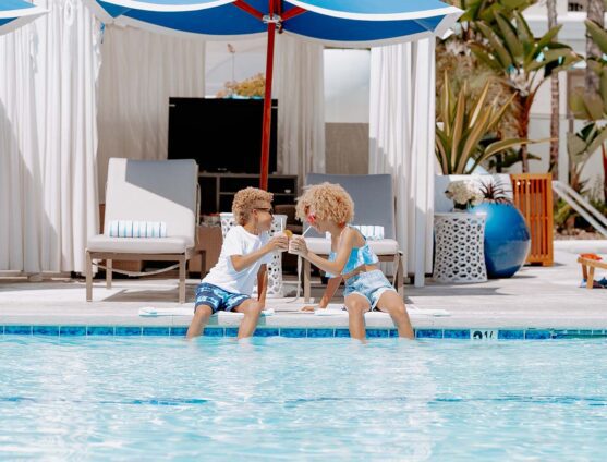 two kids having fun by the pool